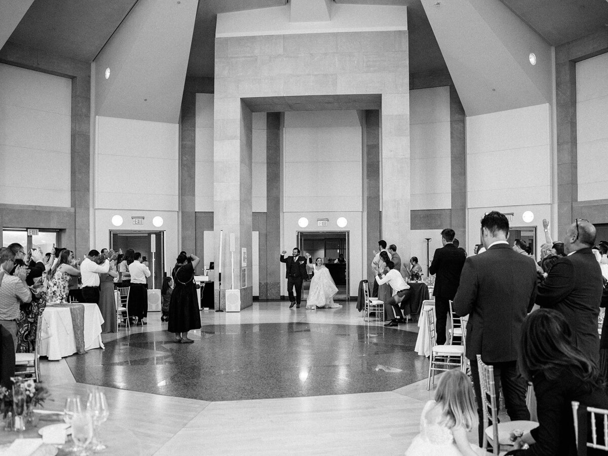 Bride and groom photo as they enter reception