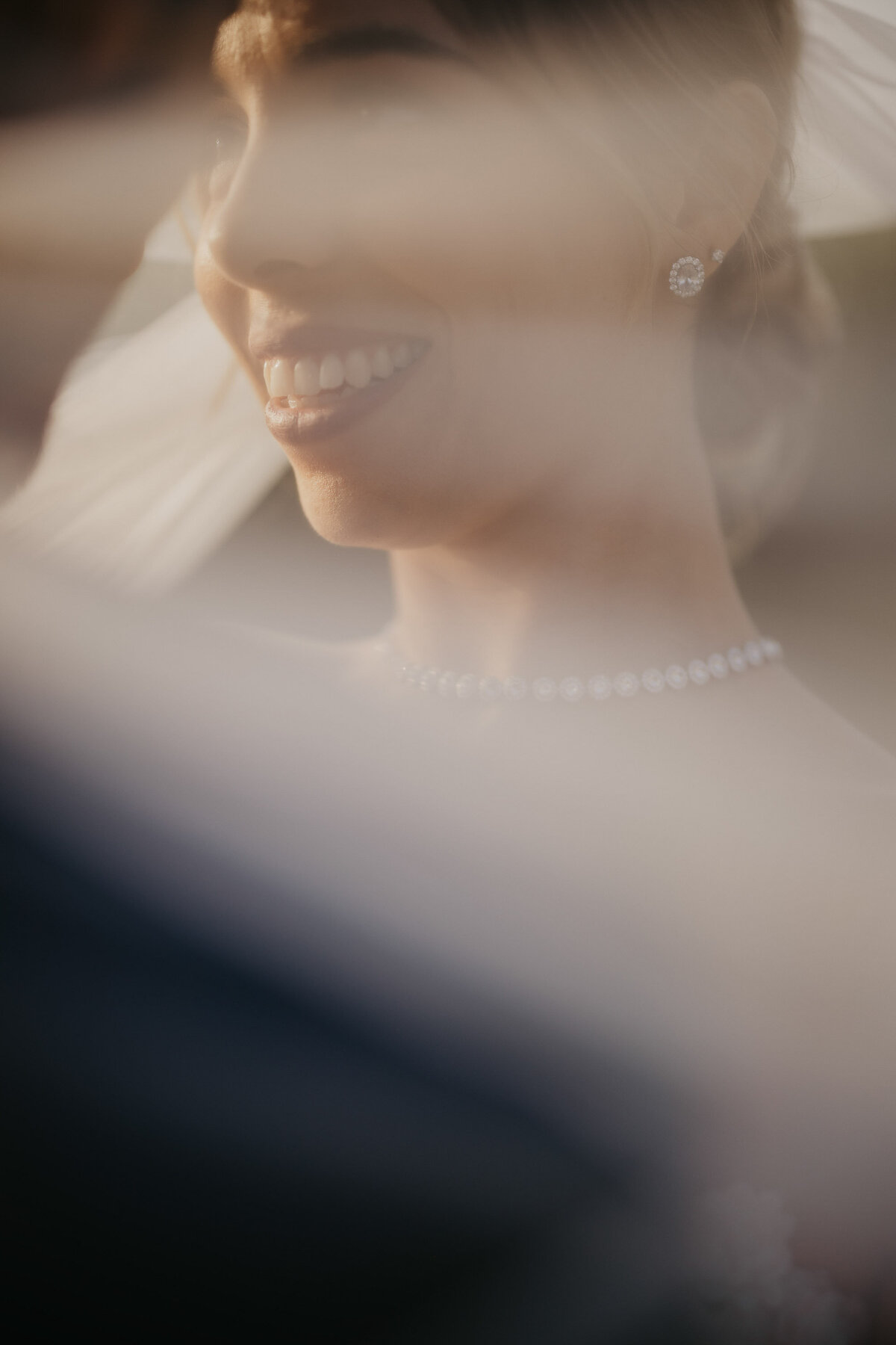 Bride’s radiant smile with soft veil light, Castello il Palagio Chianti wedding photographer Tuscany.