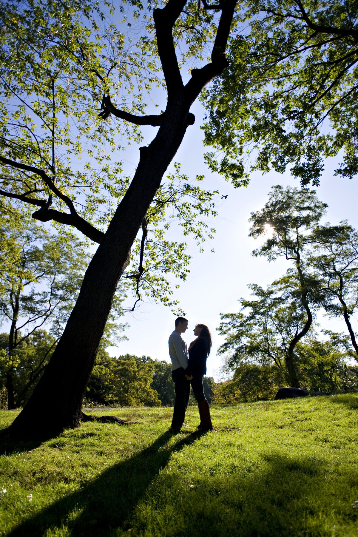 A couple holding hands and standing in a park together 