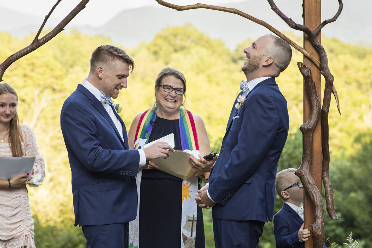 LGBTQ couple laughing during wedding ceremony at Twisty Maple wedding