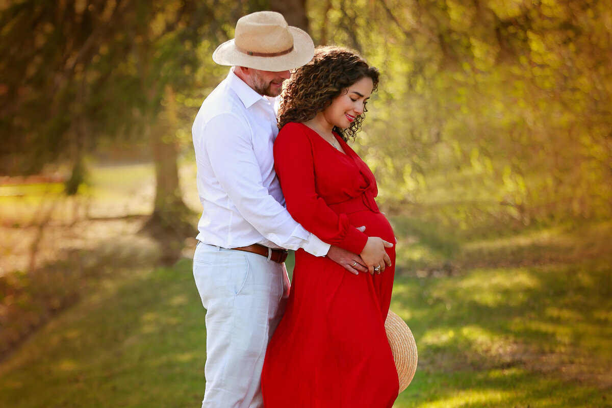 Romantic pregnancy photo session of couple in cowboy hats by Yuliia Terziian Photography