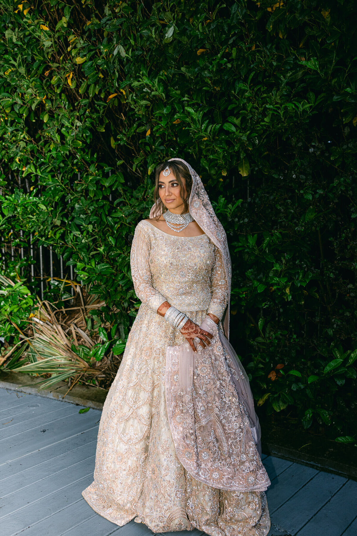 A full body wedding portrait of the bride in her flowing white dress and headpiece in Dublin Ireland
