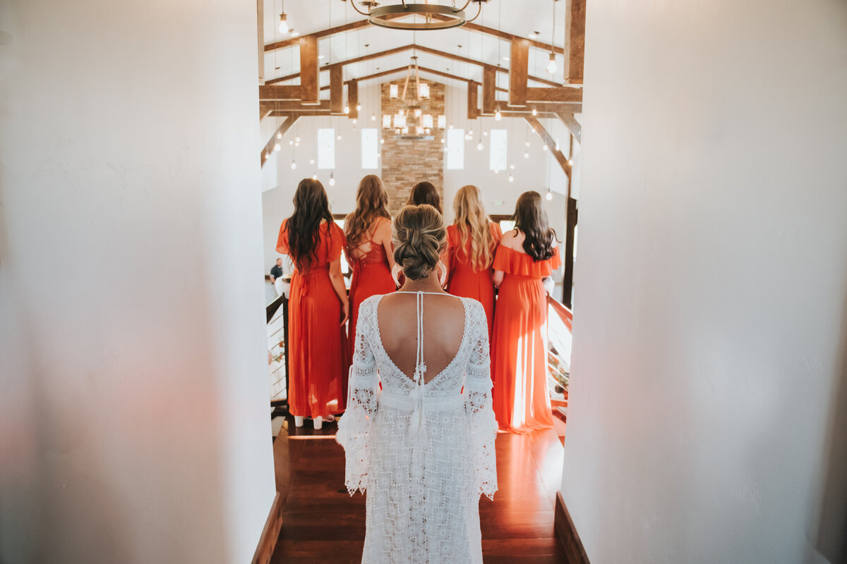 Bride showing her dress to her bridesmaids