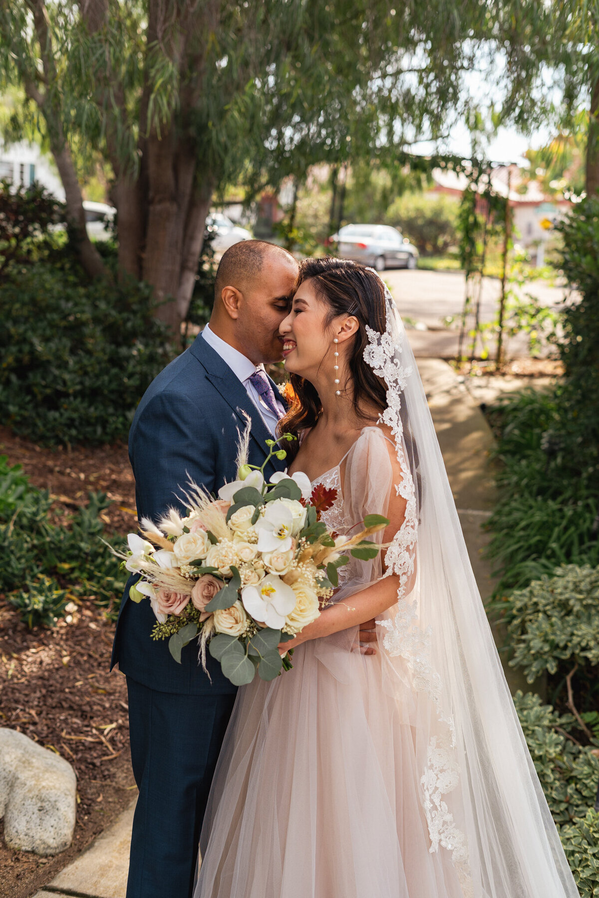 Groom gives bride a sweet kiss on the cheek