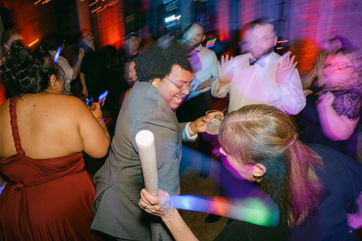 Editorial motion blur images of guests dancing at a lively and exciting luxury wedding after party.