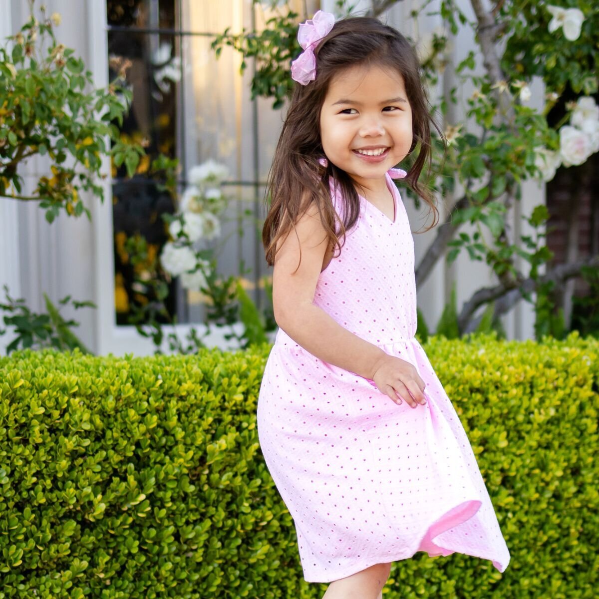 Little girl in pink dress smiling outdoors during Bay Area school photography lifestyle session – Ellobelle Photography