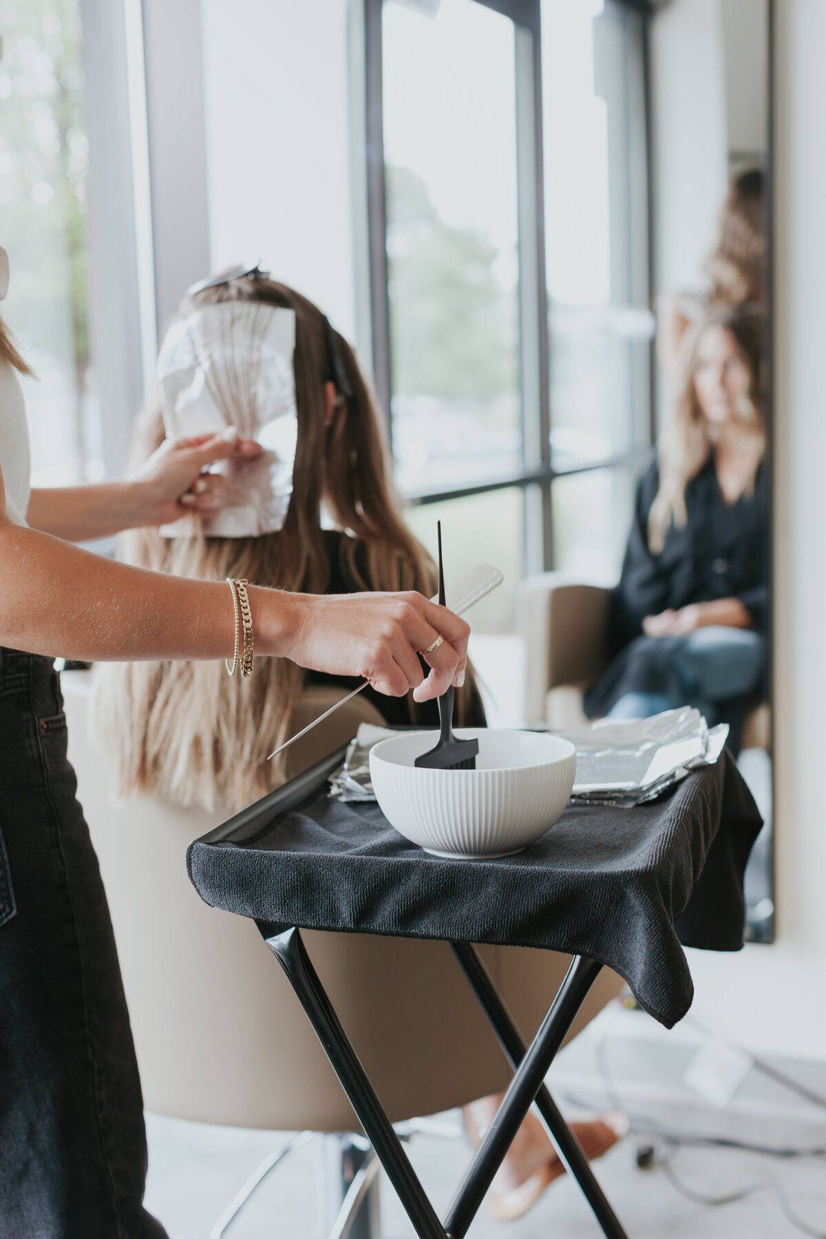 female-hairstylist-applying-hair-color-for-salon-brand-session-south-charlotte