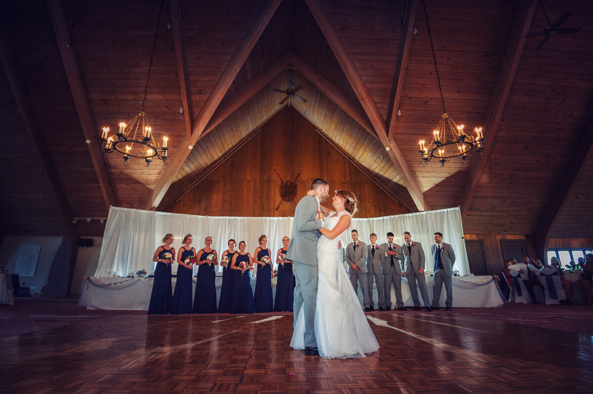 Wedding couples first dance with bridal party.