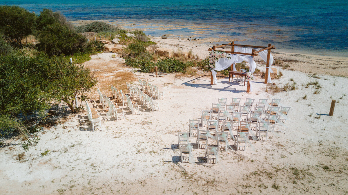 A rustic and natural beach wedding ceremony set at the waters edge