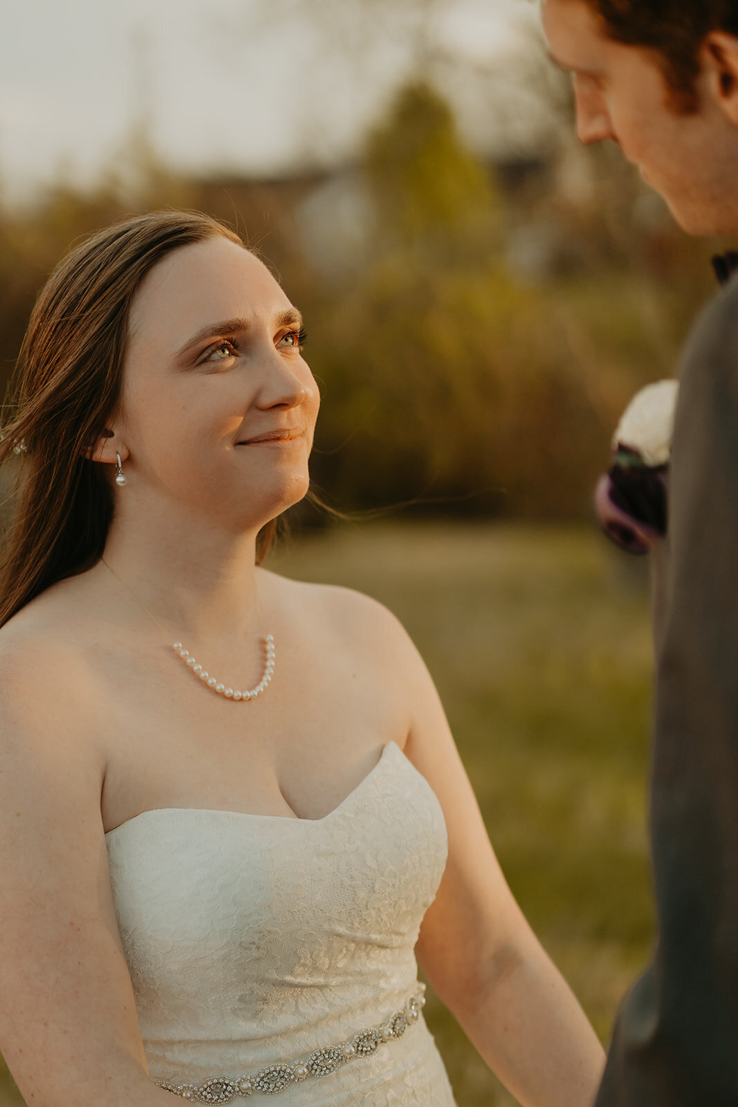 bride looking at groom at sunset