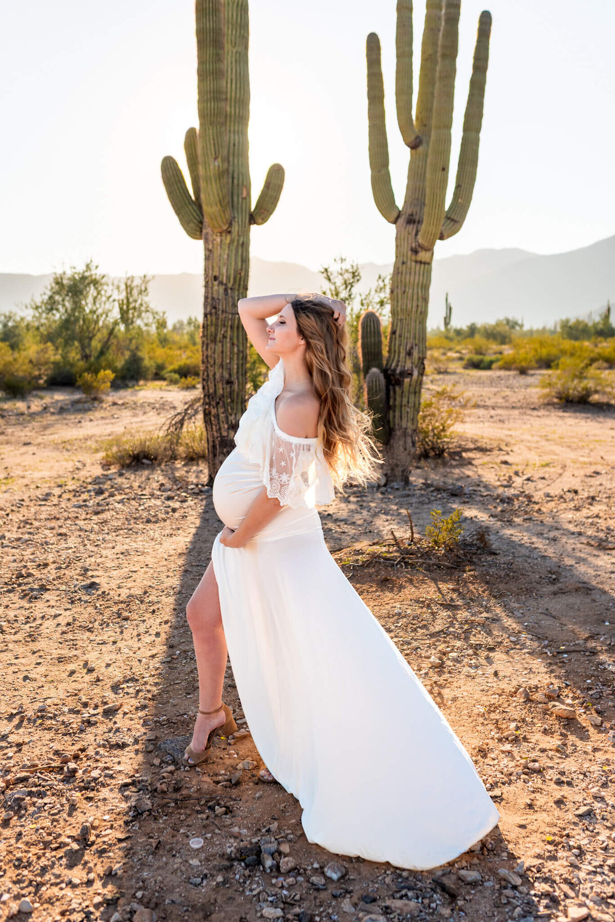 unique pose for maternity portrait of Arizona mom-to-be in white dress