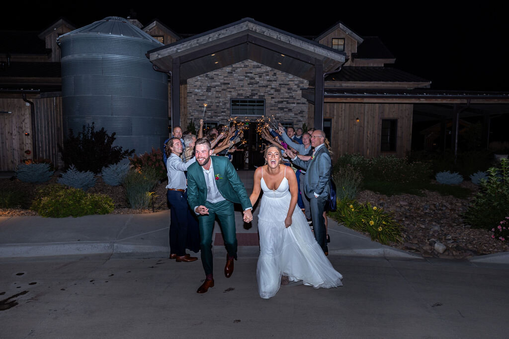 Bride and groom smiling after their grand exit at their wedding reception at Bonnie Blues Event Venue.