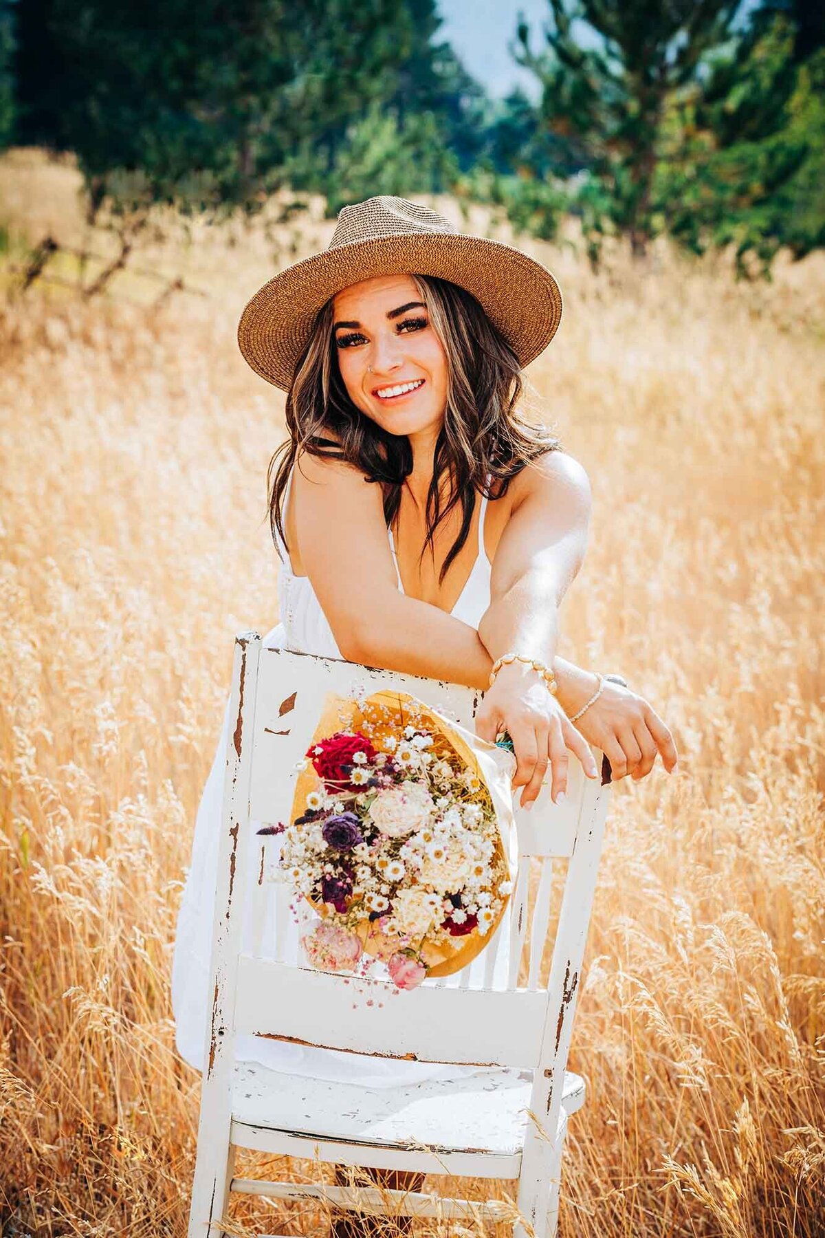 Senior photo of girl in sun hat with white chair, Missoula