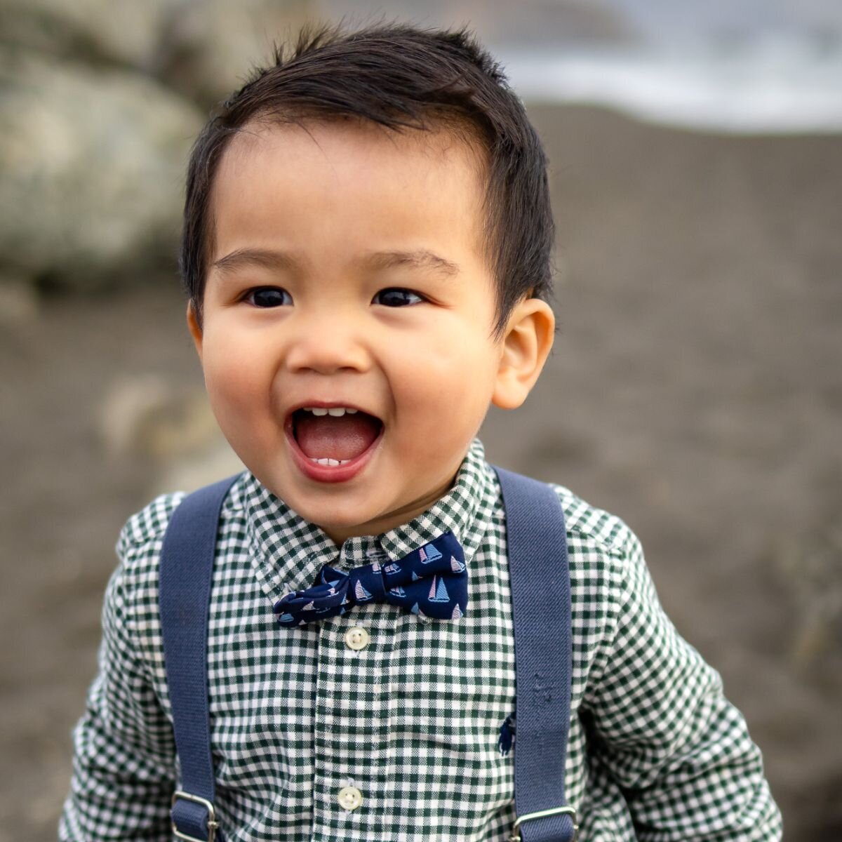 Happy toddler laughing in bow tie and suspenders during Bay Area school photography lifestyle shoot – Ellobelle Photography