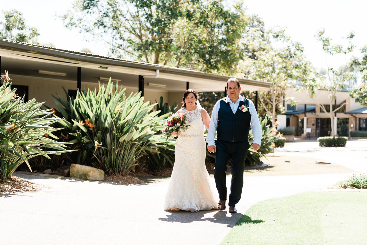bride-and-groom-walking-along-path-at-brookwater-golf-and-country-club (1 of 1)