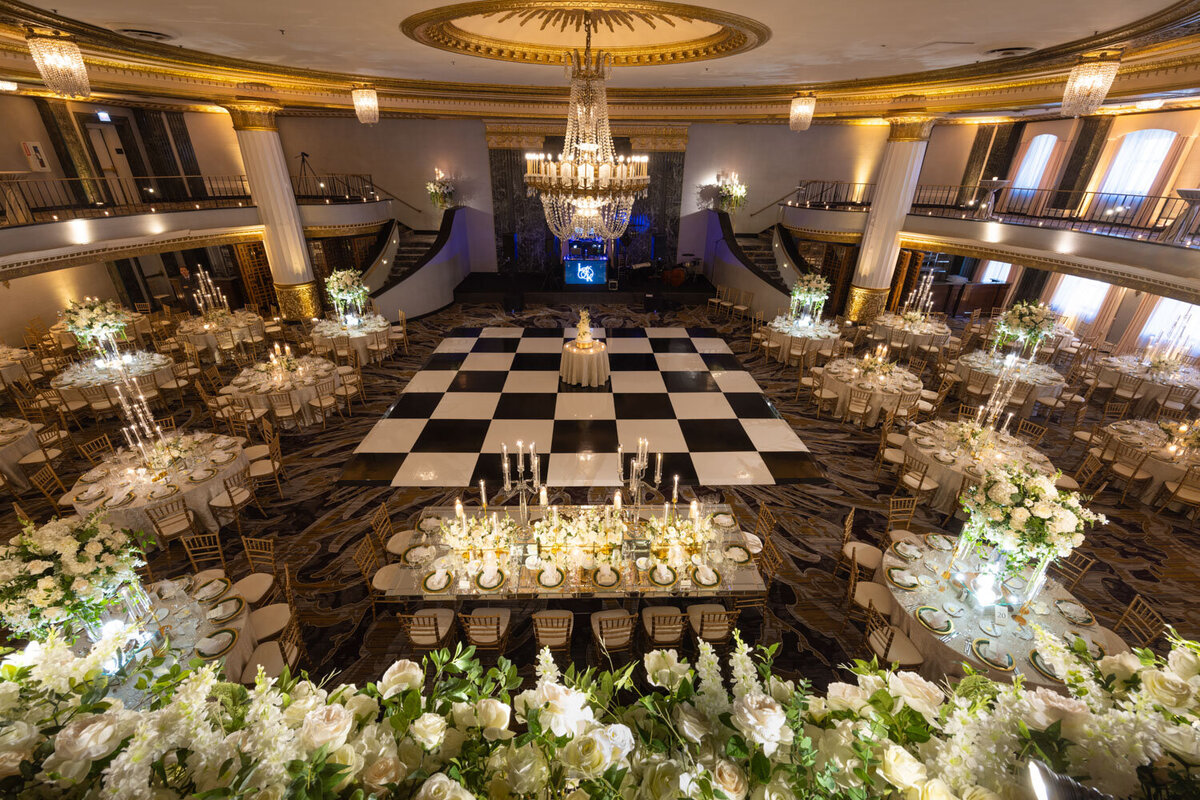 A large room with tables and chairs and a checkered floor