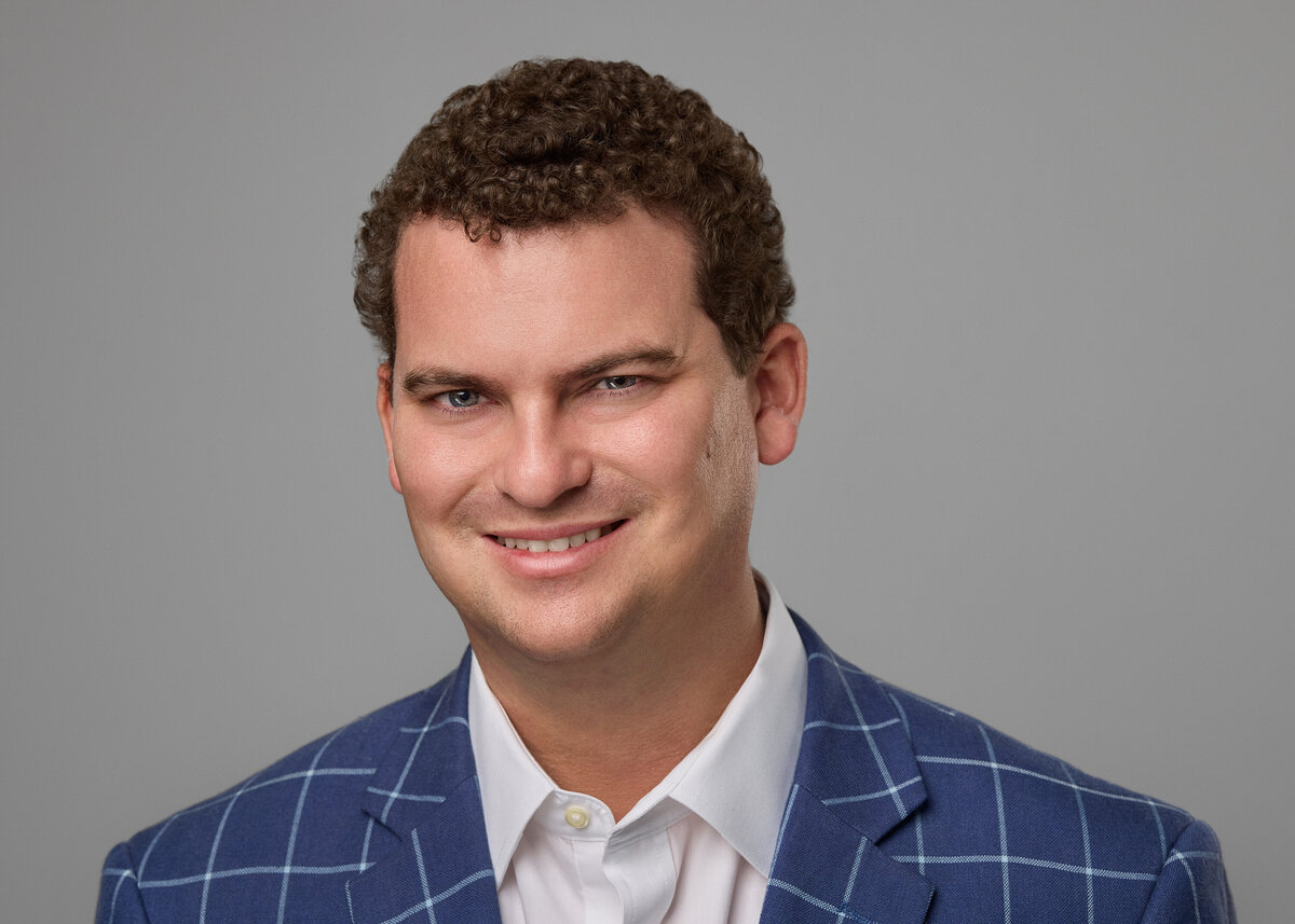 A man in a suit smiling