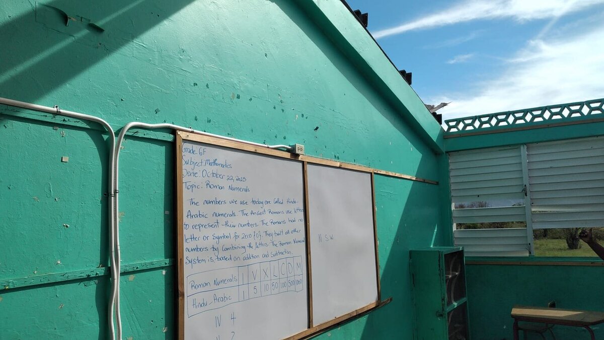 Interior view showing torn-away roof panels with the sky visible through large openings.