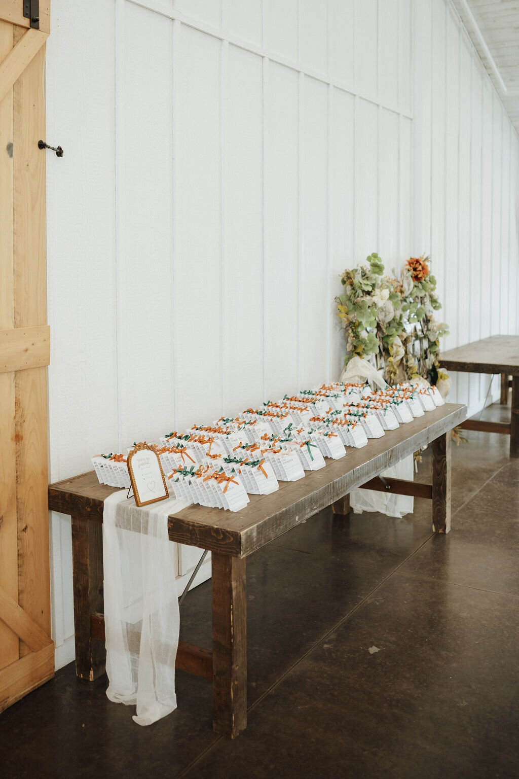 vintage gold frame with place cards sign and custom designed escort cards featuring bronze, green, white and pink ribbon details