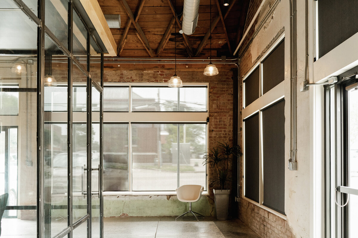 office building lobby of old building renovation with brick walls and wood structure ceiling