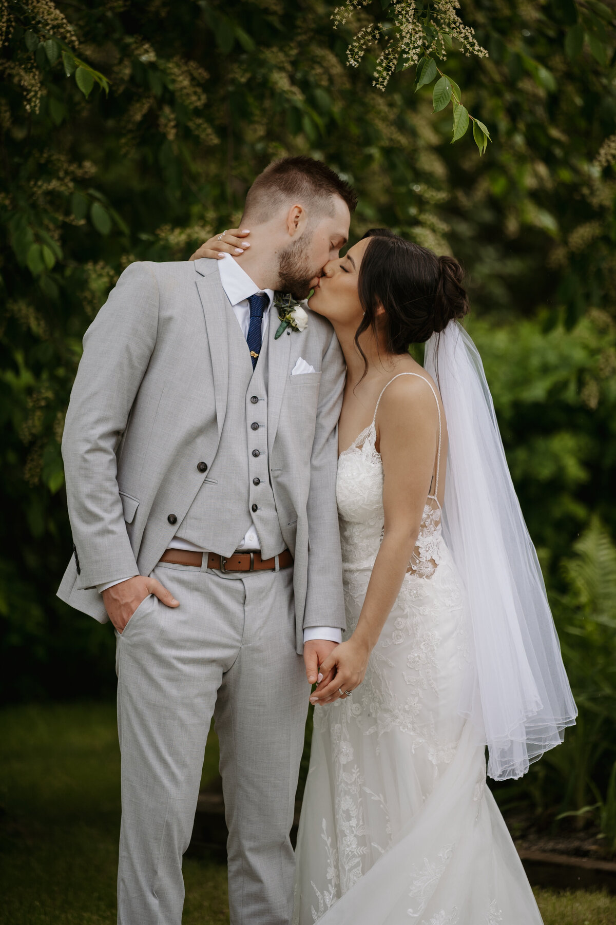 Alberta couple kissing at wedding in ceremony attire