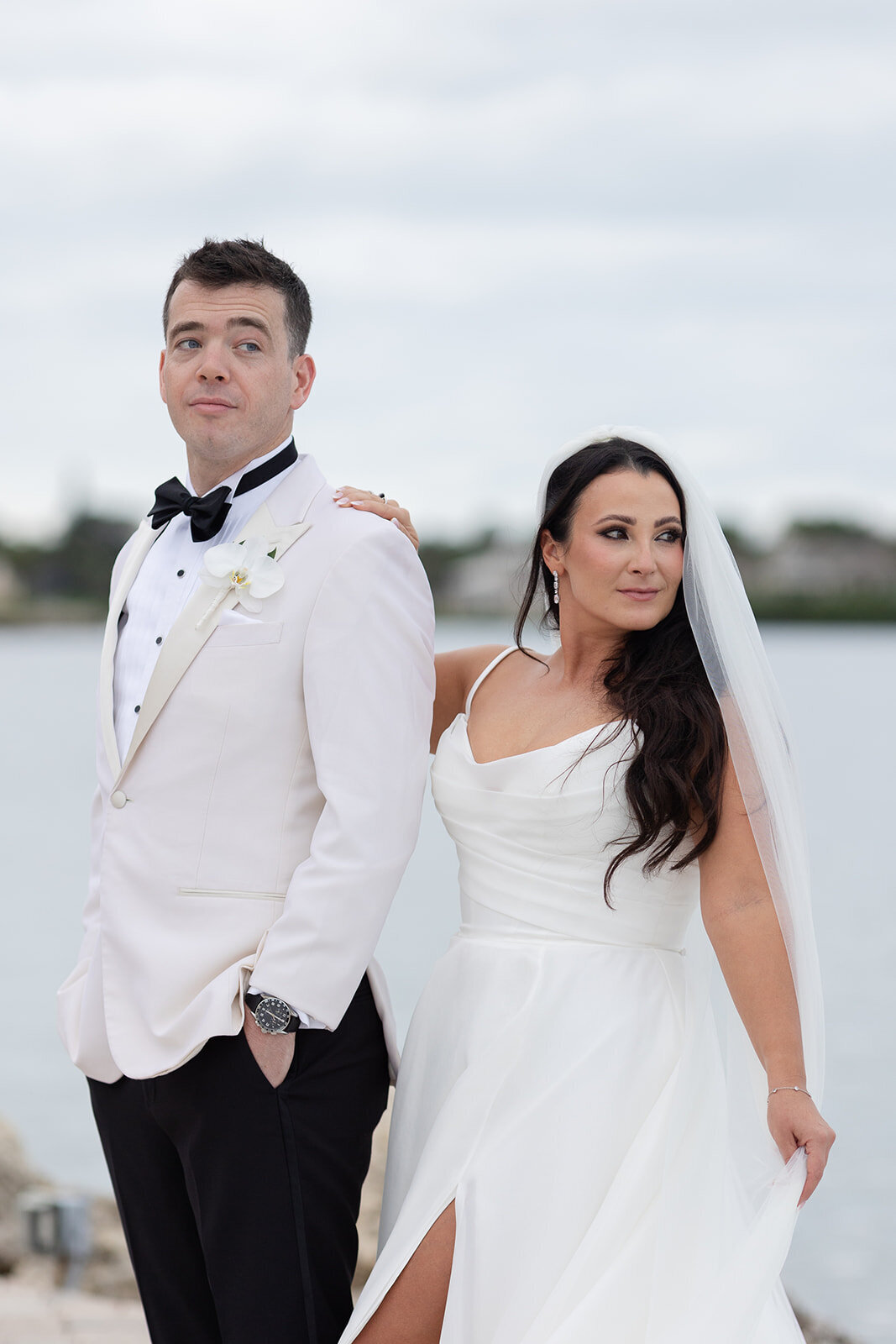 A stylish moment of the bride and groom striking a pose during their Ocean Reef wedding in Key Largo, captured by Claudia Amalia Photography.