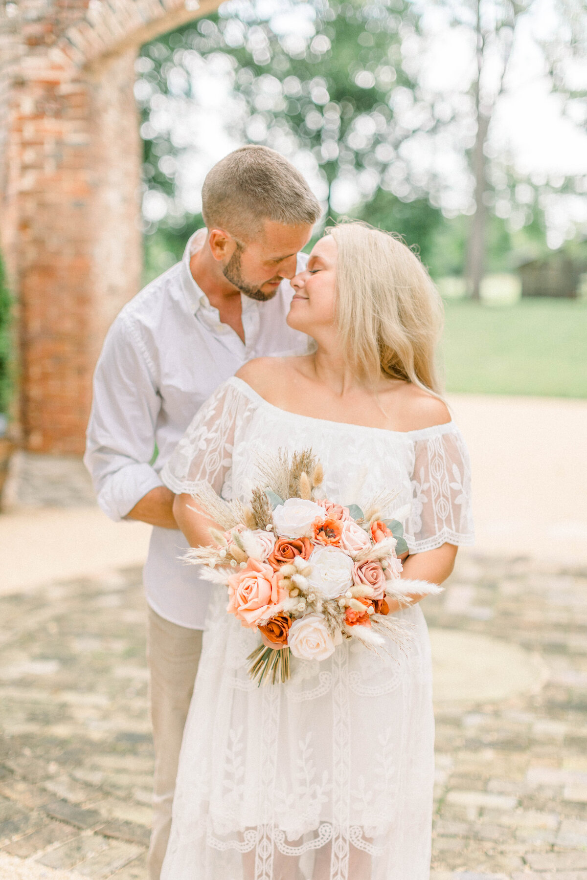 engagement photo with bouquet taken at a vintage estate in the garden