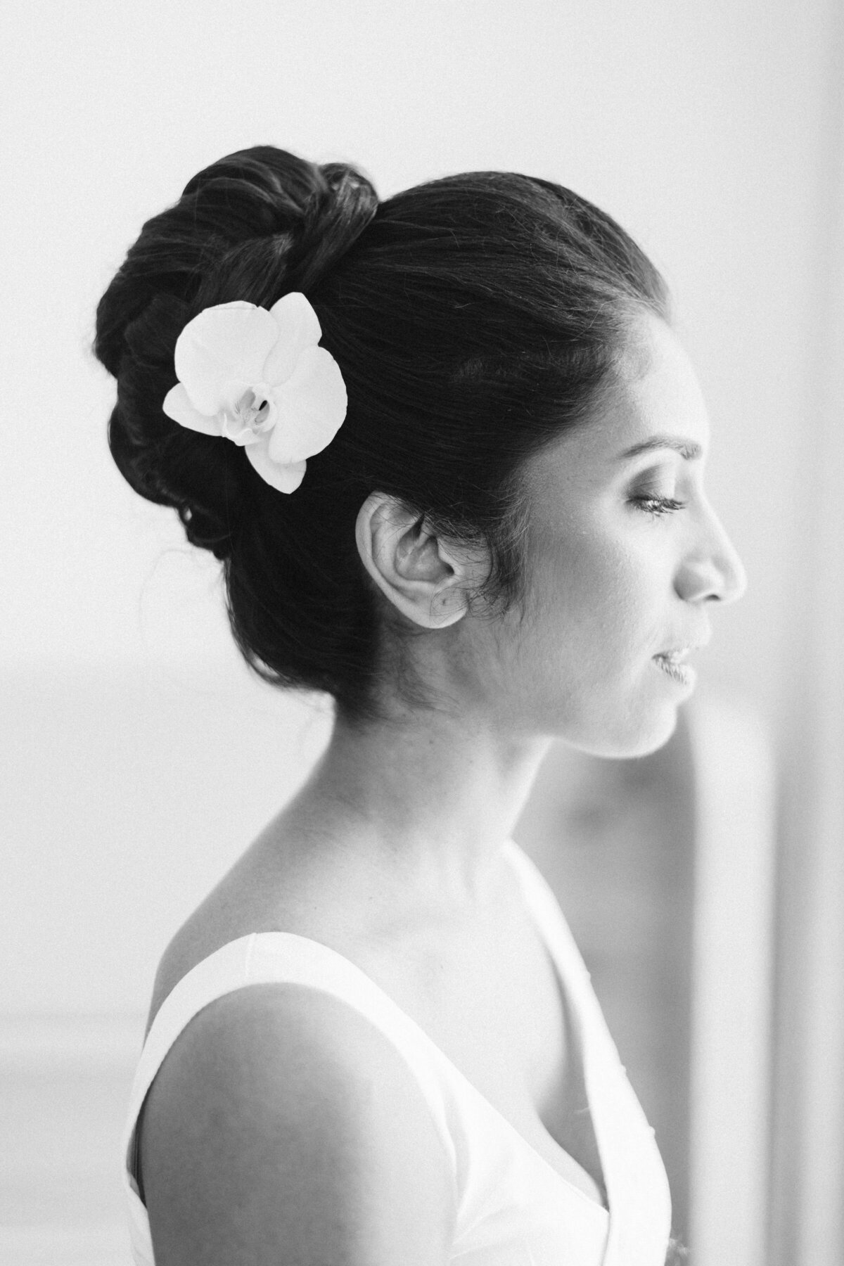bride is looking out the window at the pearle hotel