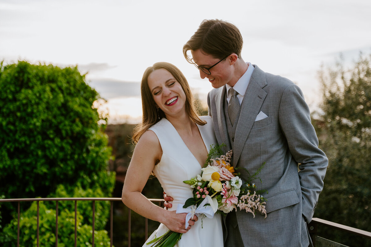 Couple hugging on Sorrento terrace at sunset