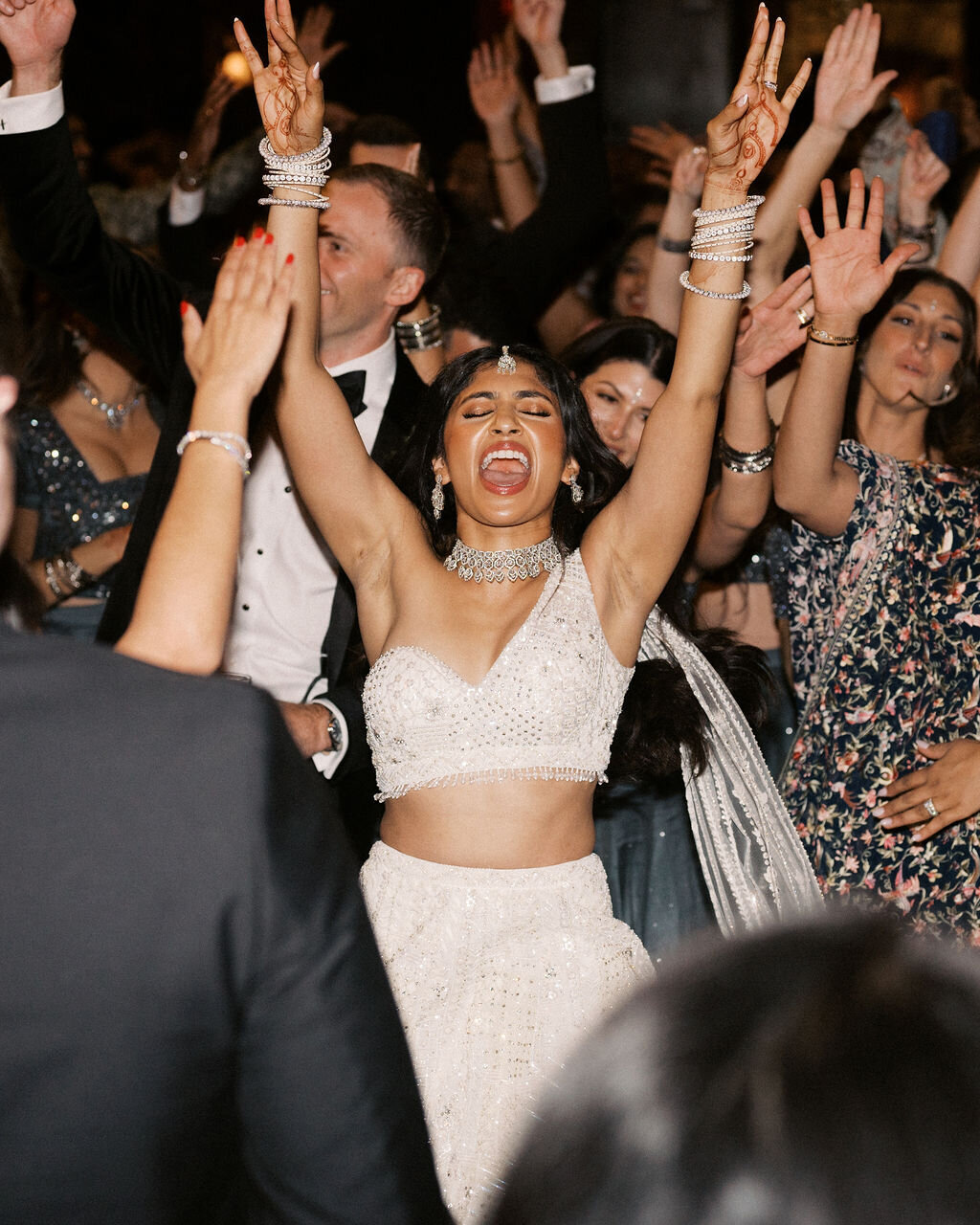 Bride throws hands up in excitement while dancing at her Old Edwards Inn wedding reception.
