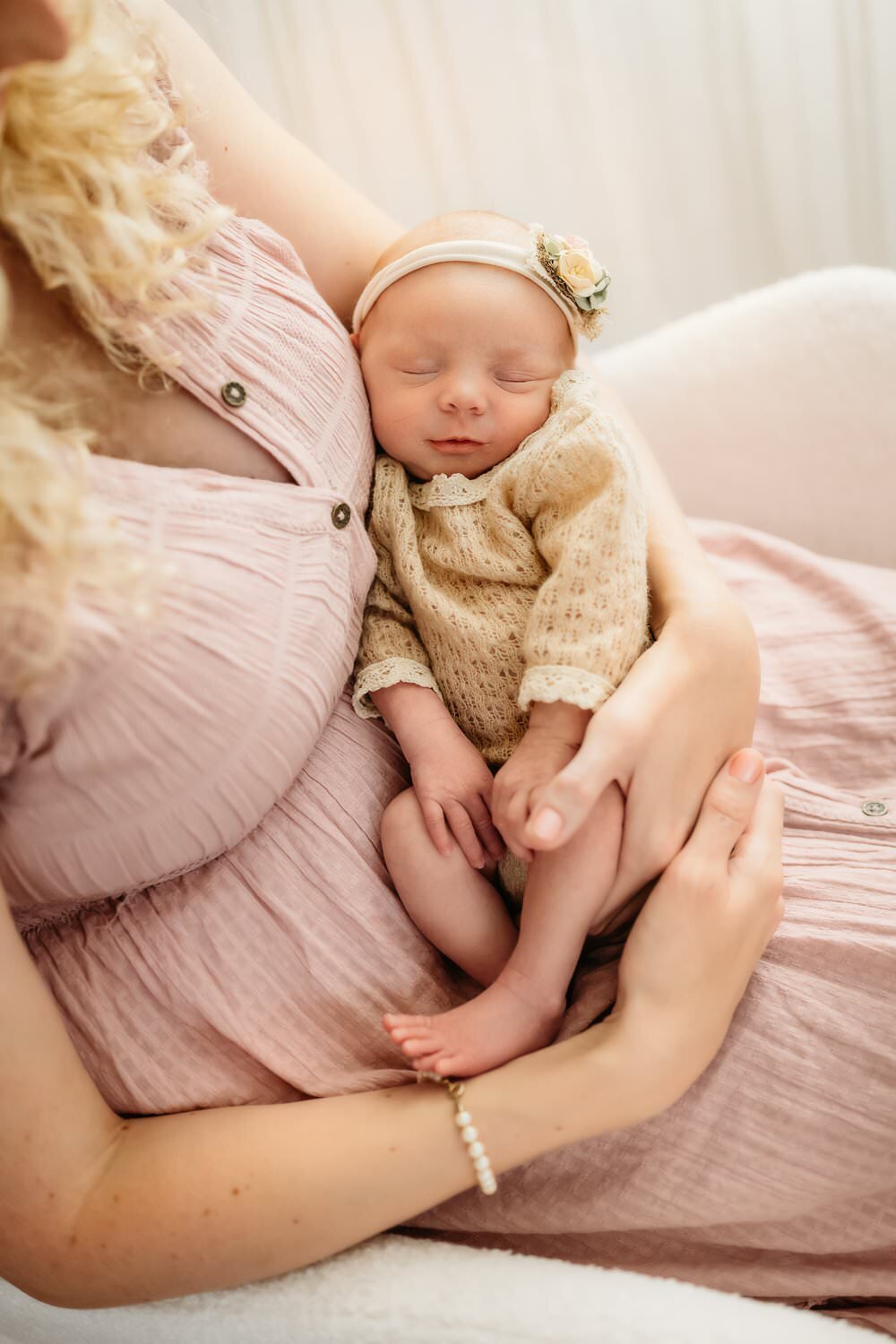 baby sleeping in her moms arms