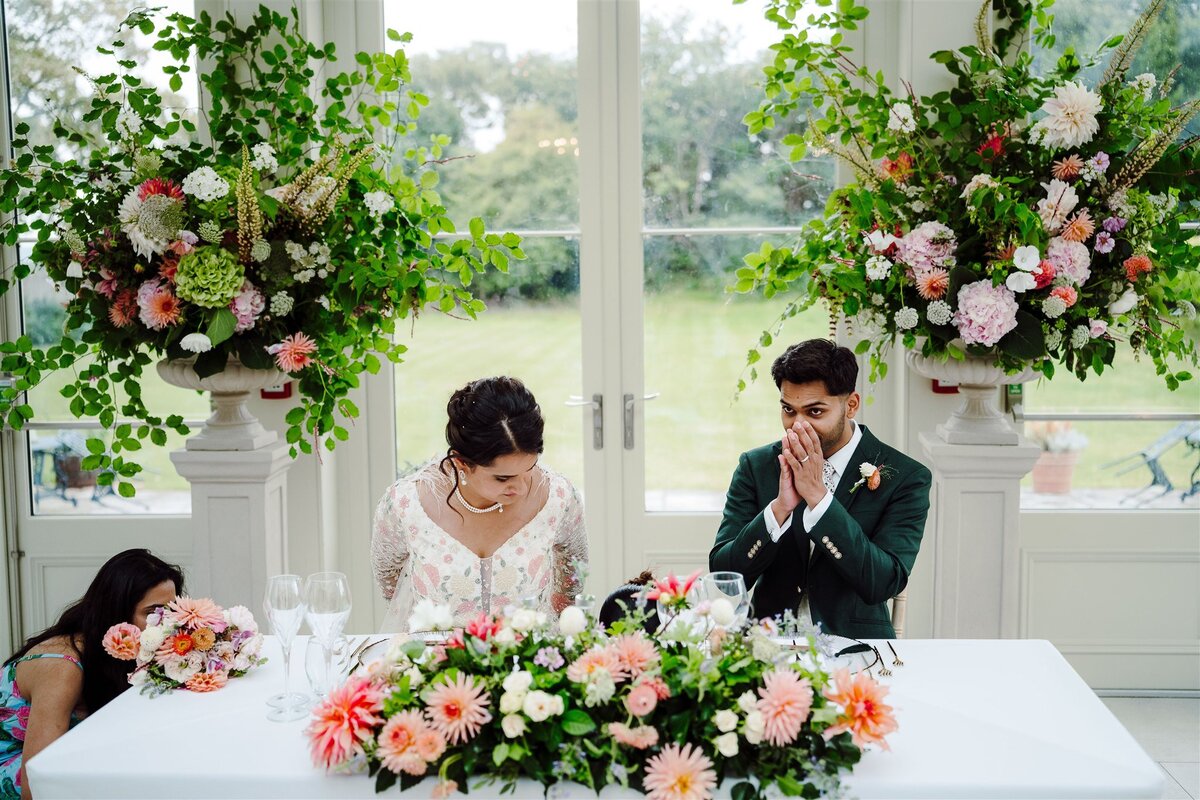 Bride and Groom in the Orangery of Clevedon Hall, sweet heart table 