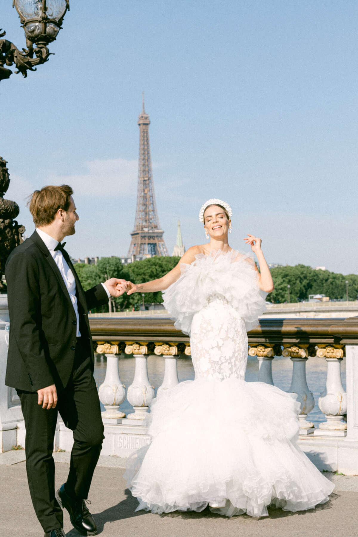 A wedding photo of a bride in her white dress in the streets of Paris in France.