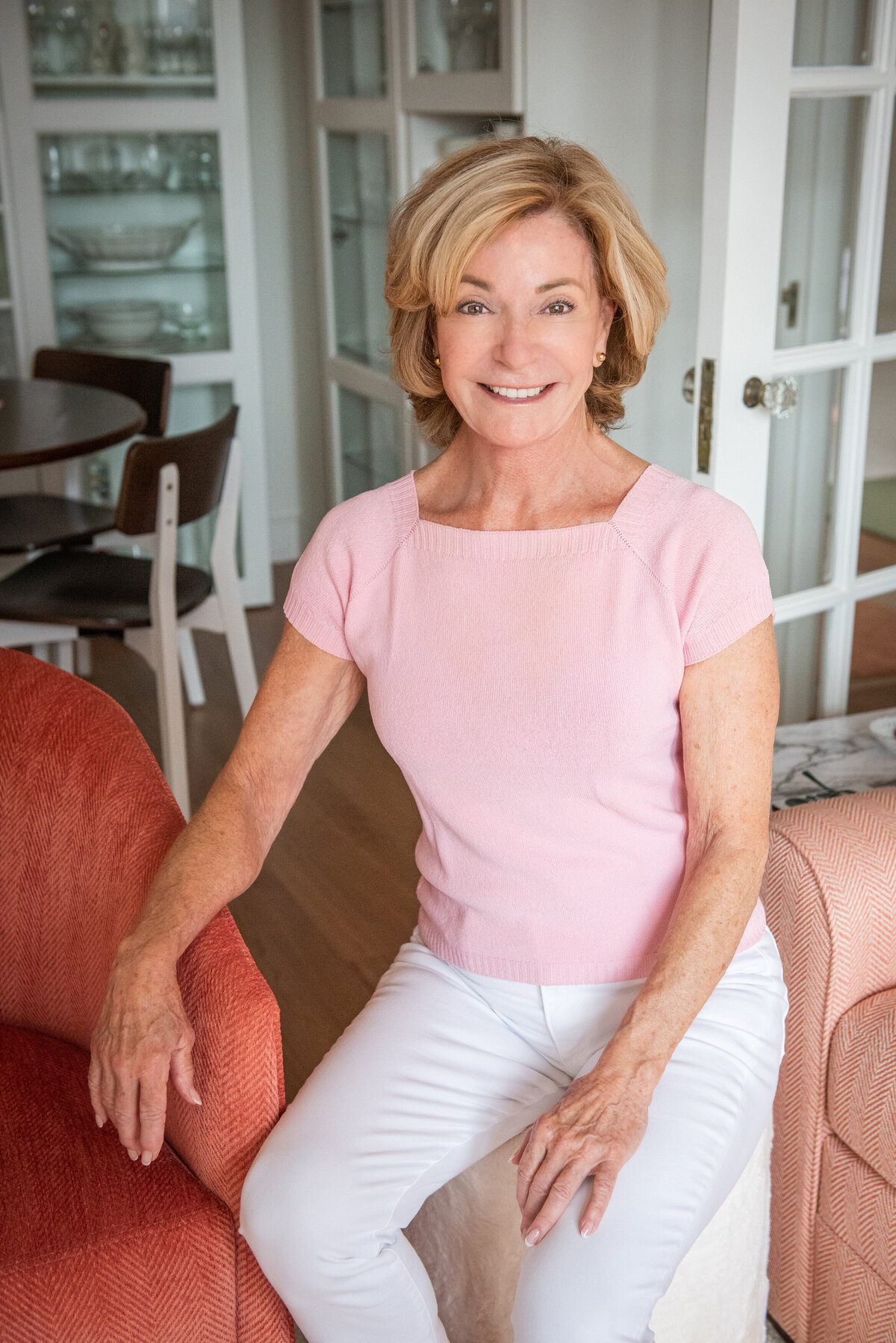 A person sitting on a side table smiling