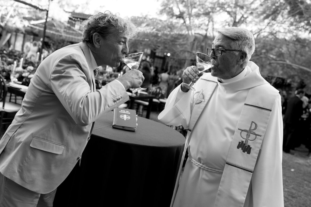 a guest and a pastor drinking martinis together during cocktail hour. 