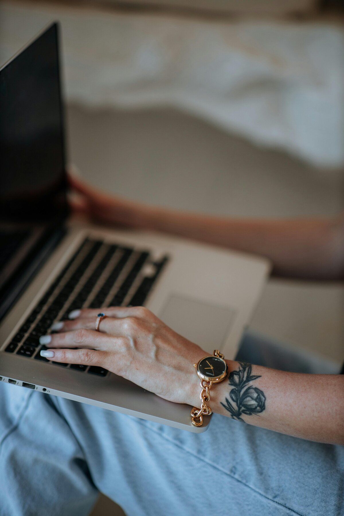 Close-up of hands typing on a laptop keyboard, illustrating the onboarding and setup process for virtual assistant and web design services.