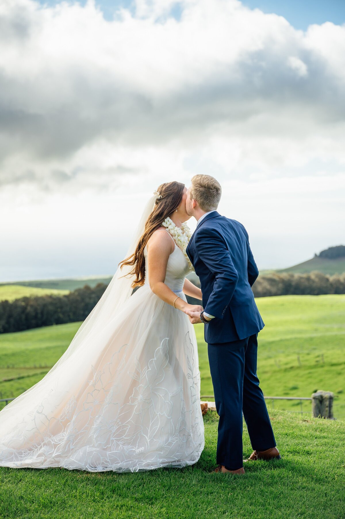 groom gives bride a kiss on the cheek after the lei exchange ceremony