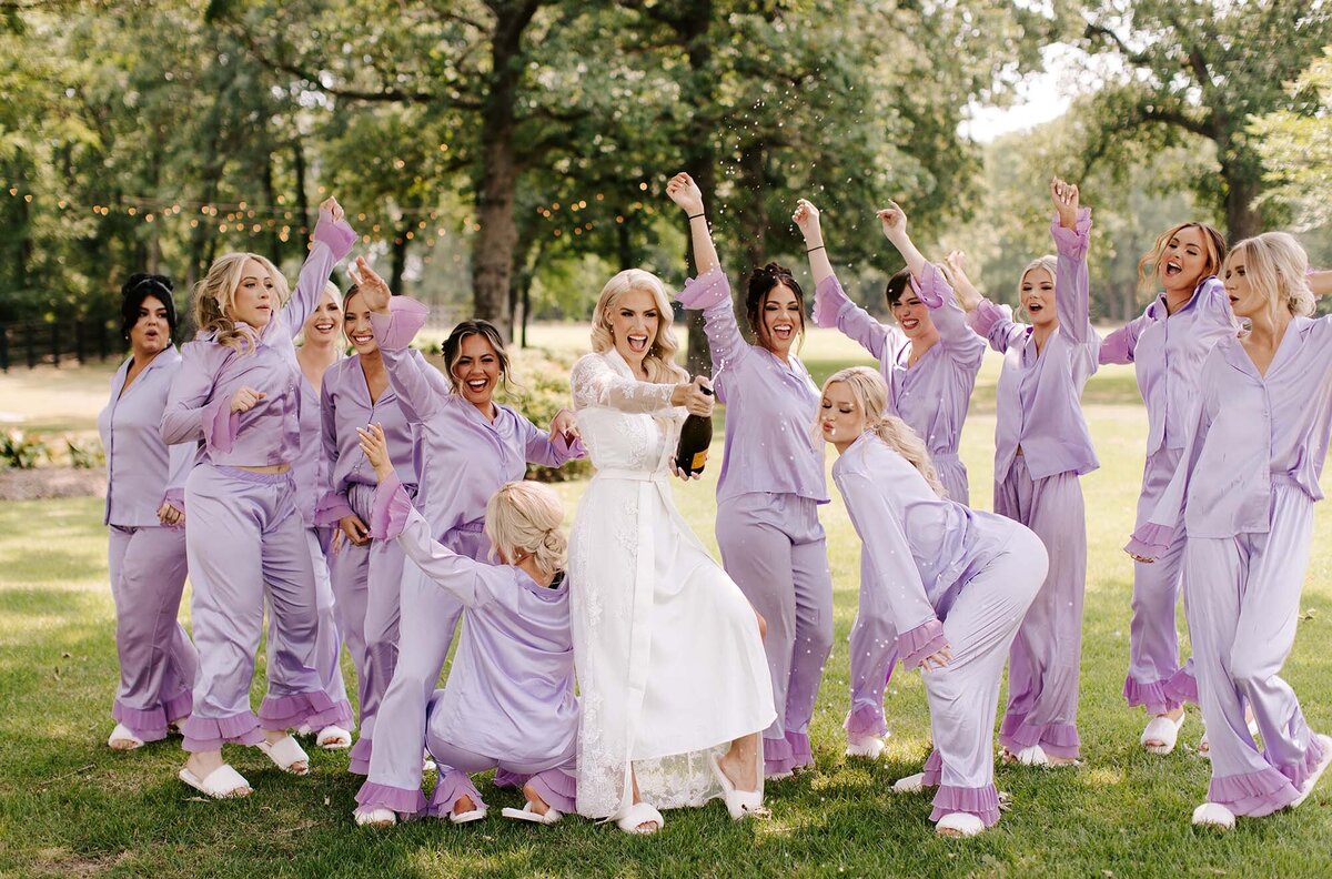 bride-with-bridesmaids-popping-champagne