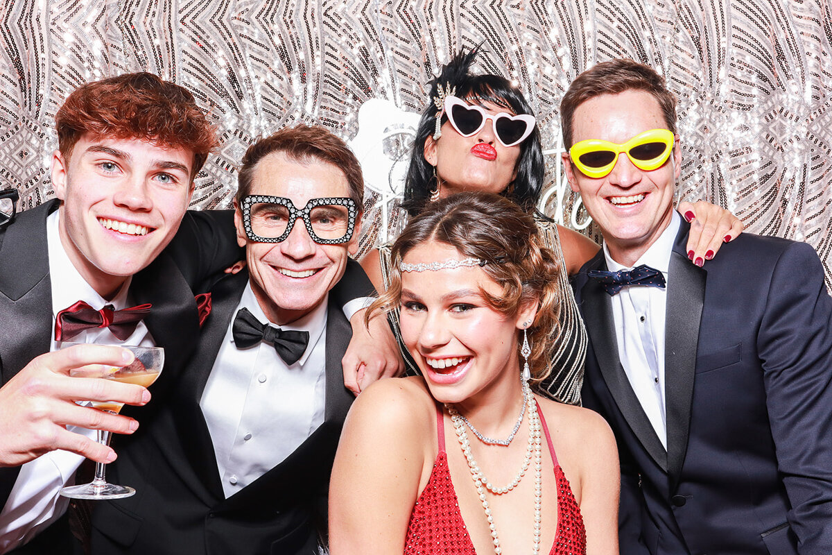 beautiful family and birthday girl wearing a smart dress while posing for a selfie pod photo booth hire in cheltenham