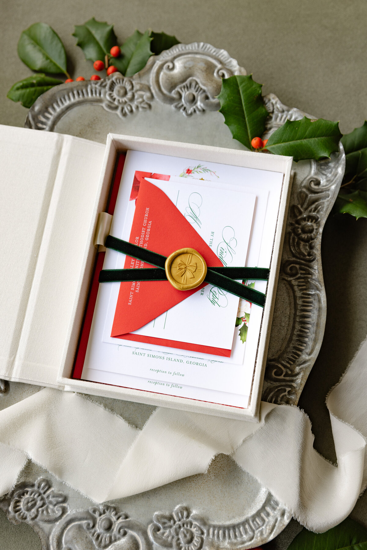 red and green stationery for a Christmas wedding in a white box