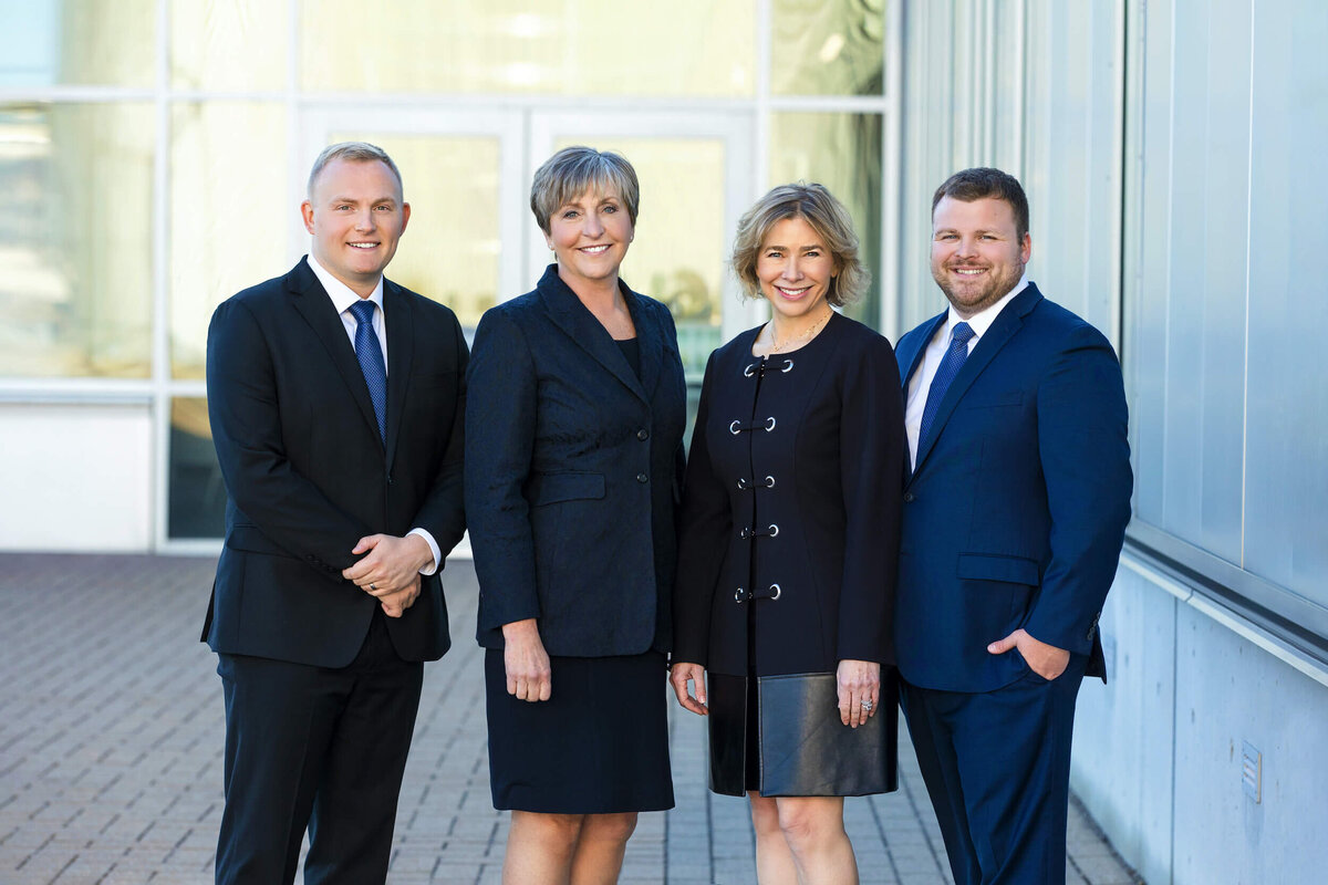 four-business-people-standing-outside