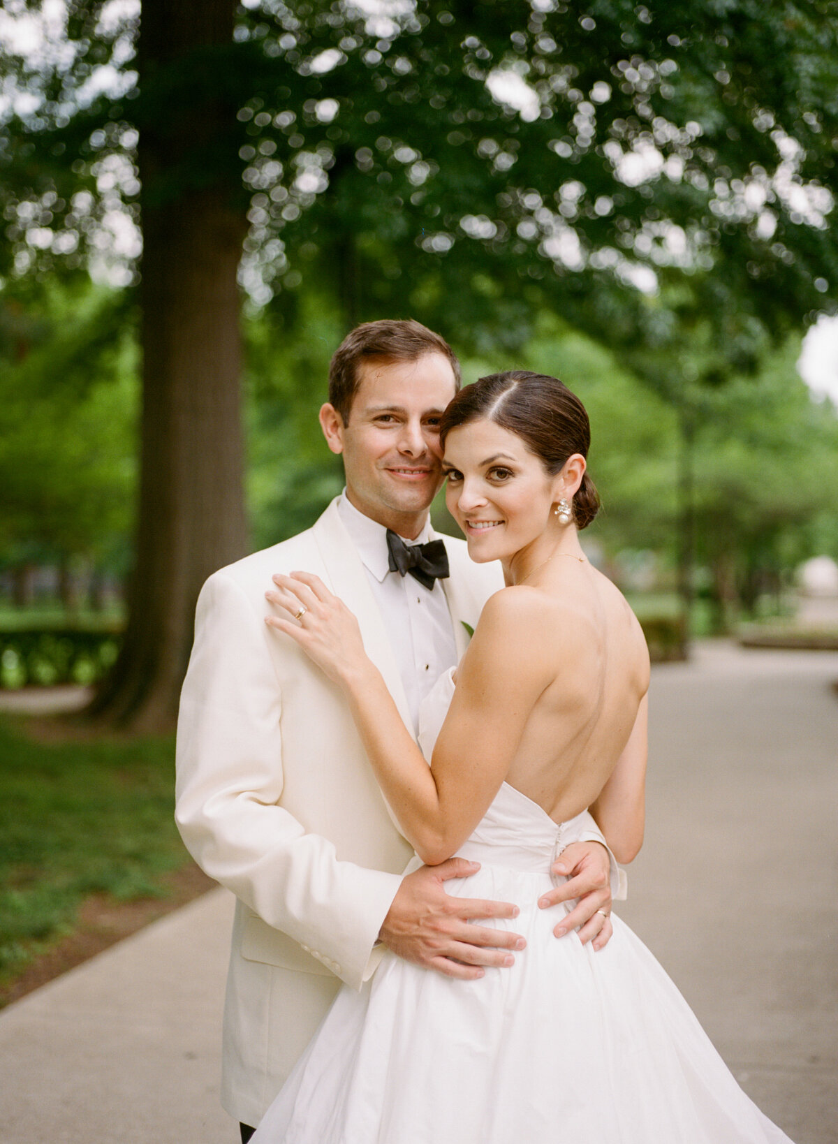 image of bride and groom holding each other outdoors