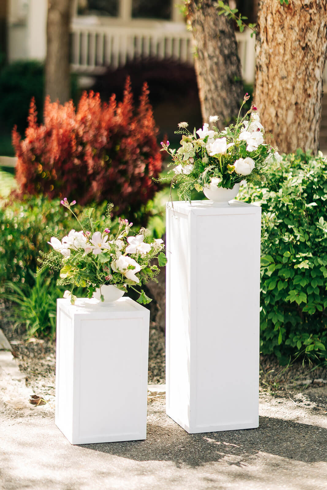 Two flower bouquets placed on top of white boxes at an outdoor wedding in Boise
