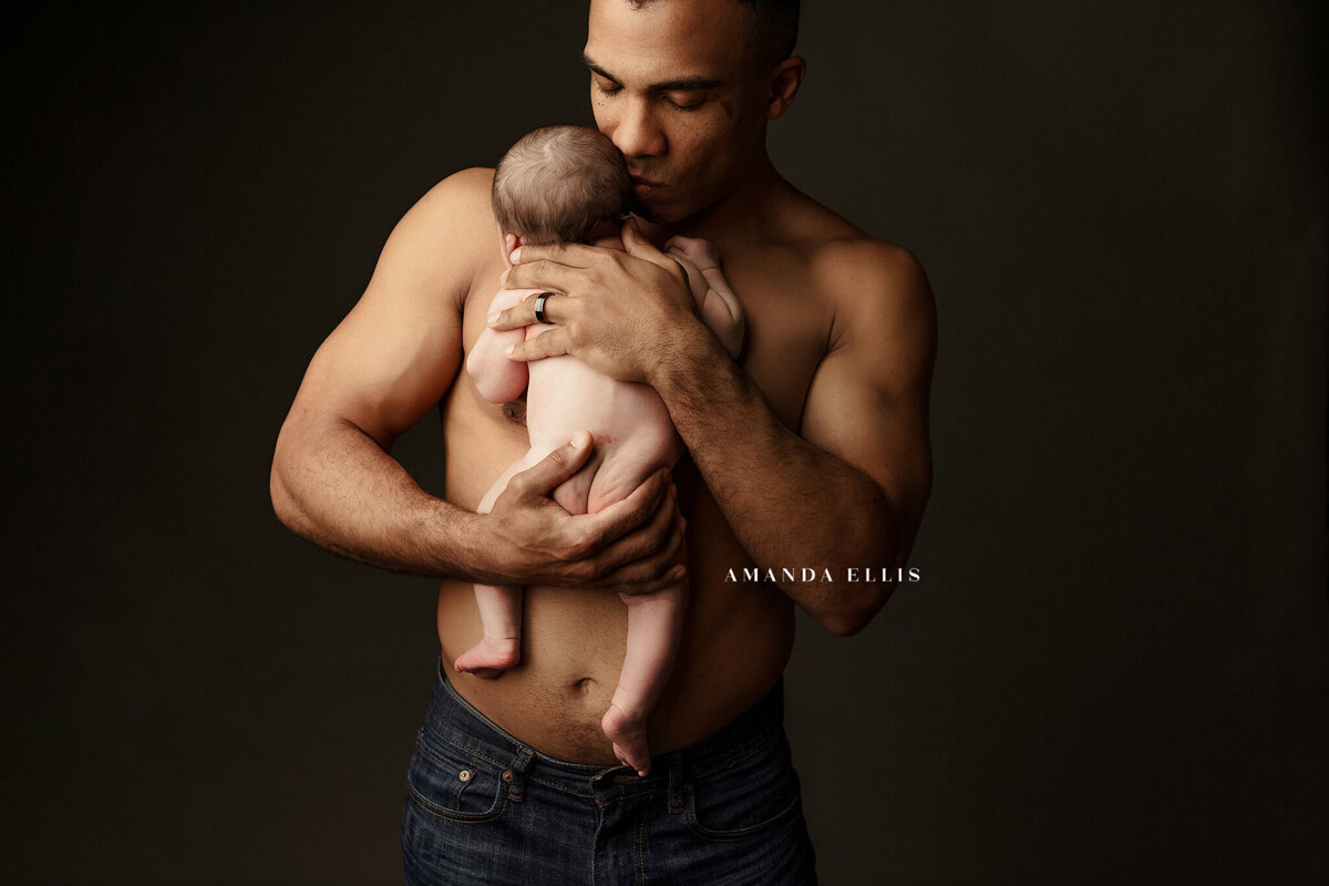 Dark luxury portrait of father and newborn