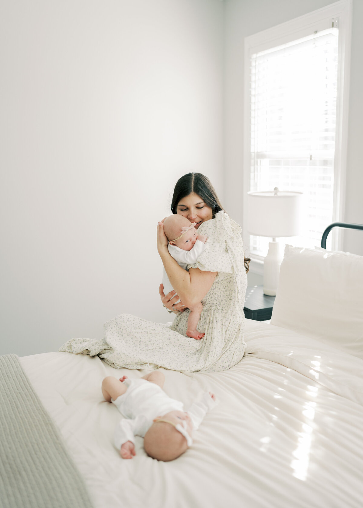 Women holding baby in arms while baby is sleeping in Richmond newborn session 