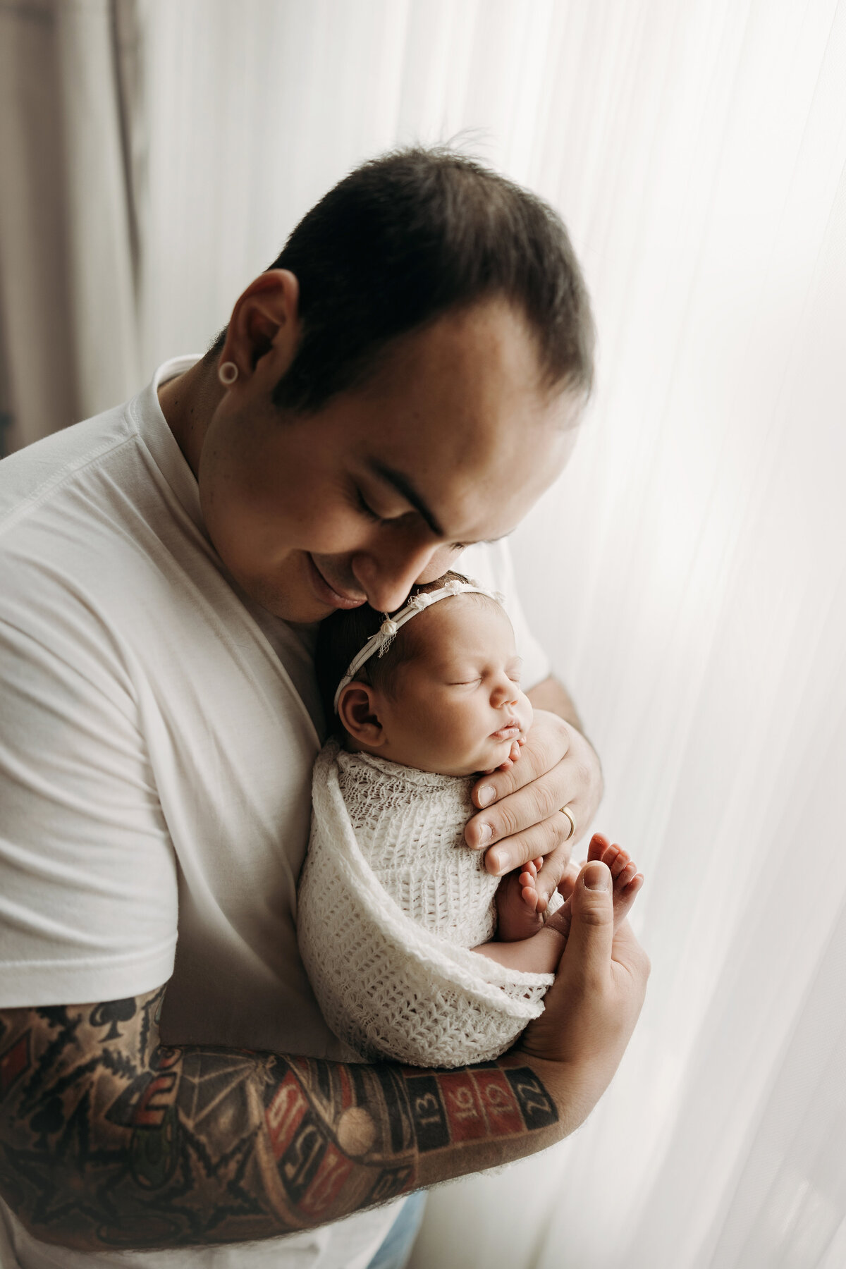 Fort Collins dad holding newborn baby girl