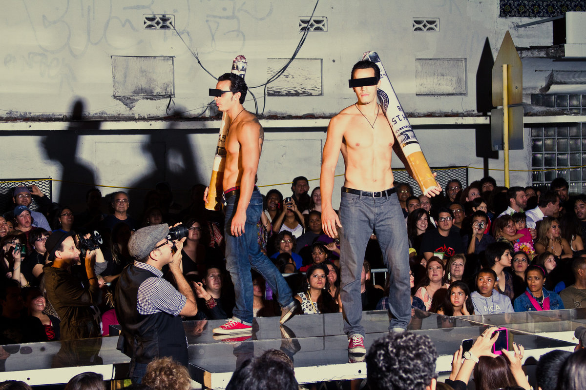 two male models posing on fashion runway for Una Noche en la Gloria Runway en la Calle