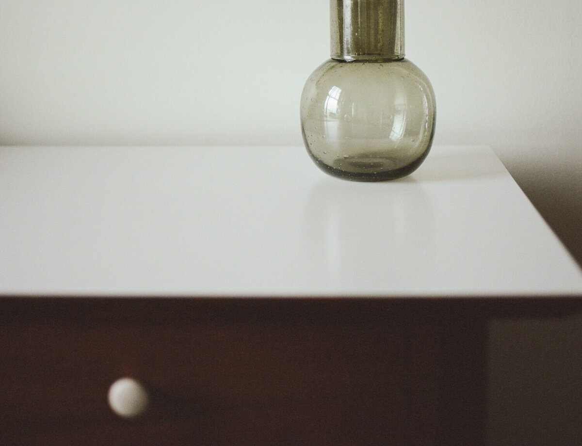 handblown green glass round carafe with cup, interior photography design details at ALEO Detroit
