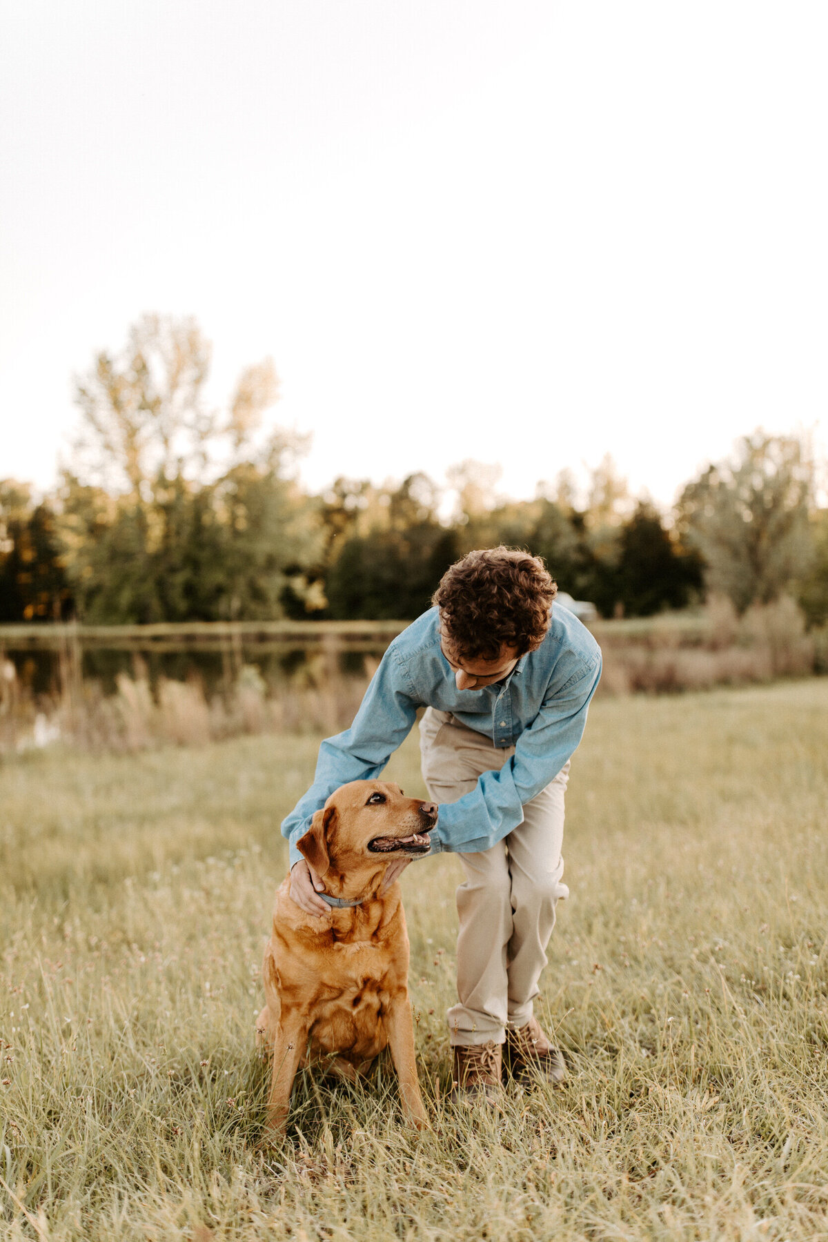 Senior boy in a field with his dog