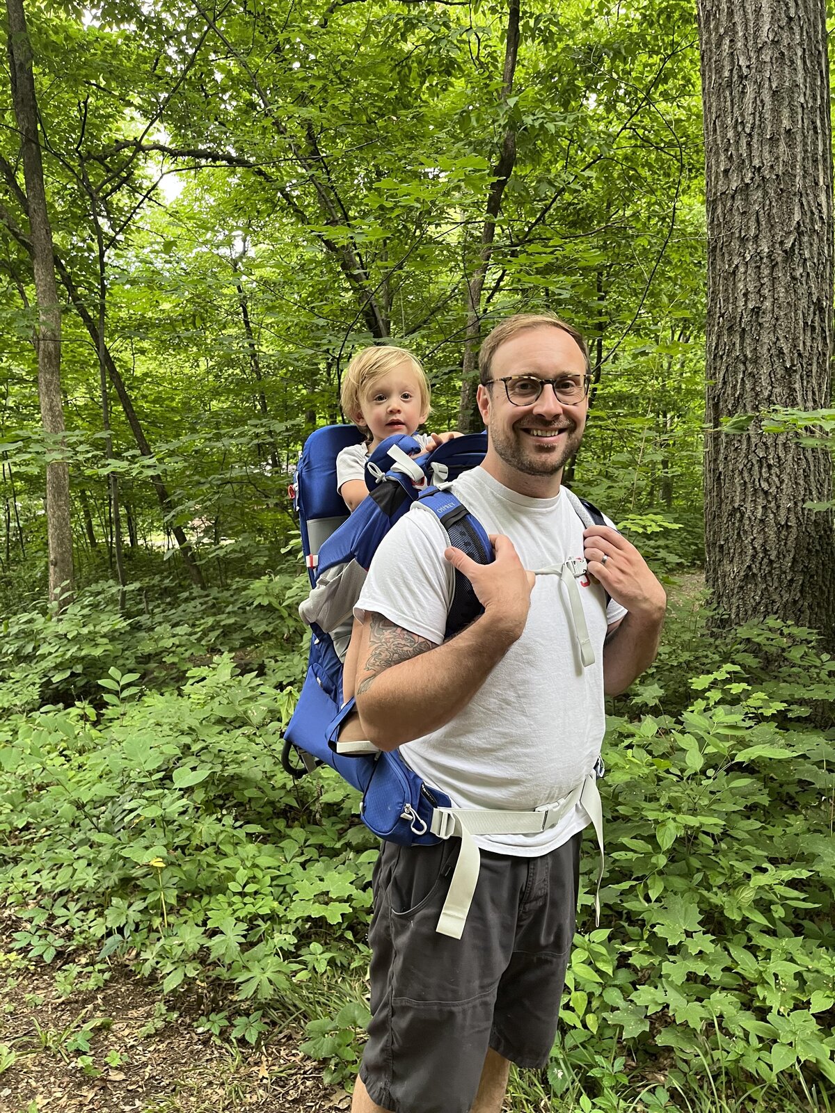dad with toddler in backpack ready for a hike